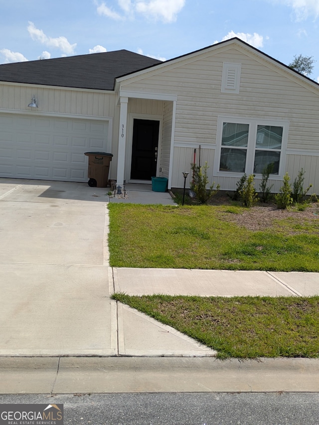 310 Lillian St, Rincon, GA 31326 - view of front of house featuring driveway, a front yard, an attached garage, and a shingled roof
