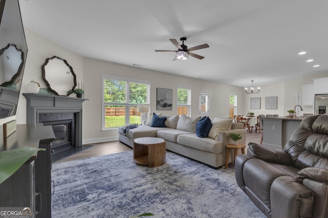 206 Roundwood Way, Peachtree City, GA 30269 - living area featuring a chandelier, a ceiling fan, recessed lighting, a fireplace, and wood finished floors