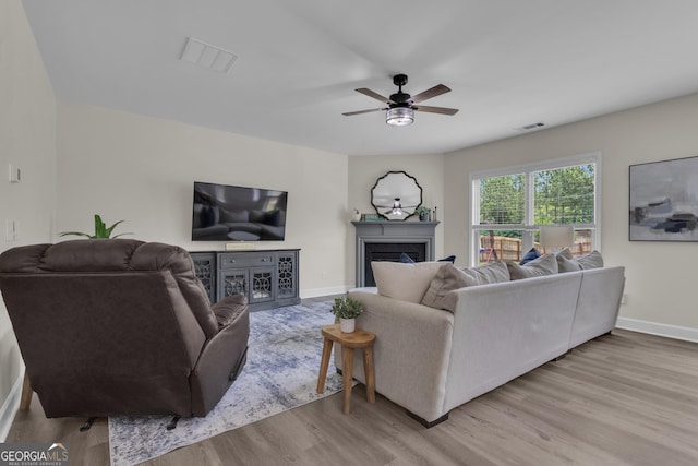 206 Roundwood Way, Peachtree City, GA 30269 - living room featuring wood finished floors, a ceiling fan, and a fireplace