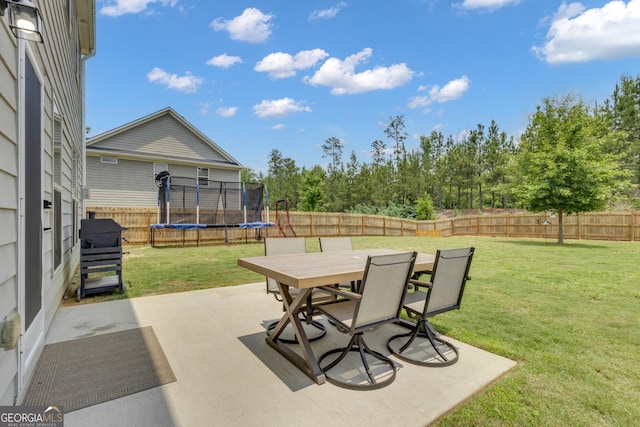 206 Roundwood Way, Peachtree City, GA 30269 - fenced backyard featuring a trampoline, a patio area, and outdoor dining area