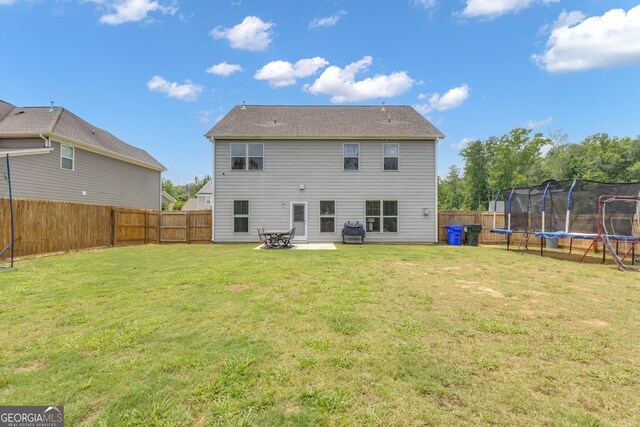 206 Roundwood Way, Peachtree City, GA 30269 - back of property featuring a trampoline and a fenced backyard