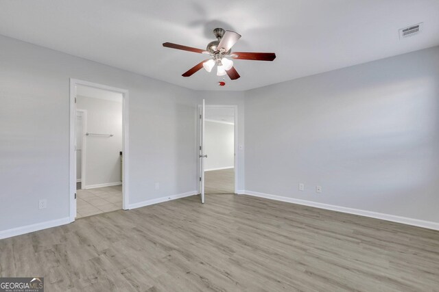 17 Sandy Point Way, Port Wentworth, GA 31407 - unfurnished bedroom featuring wood finished floors, baseboards, ceiling fan, and connected bathroom