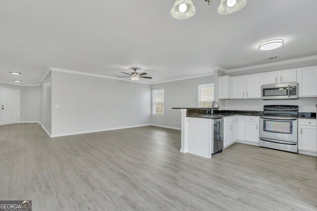 17 Sandy Point Way, Port Wentworth, GA 31407 - kitchen featuring stainless steel appliances, open floor plan, ornamental molding, ceiling fan, and white cabinets