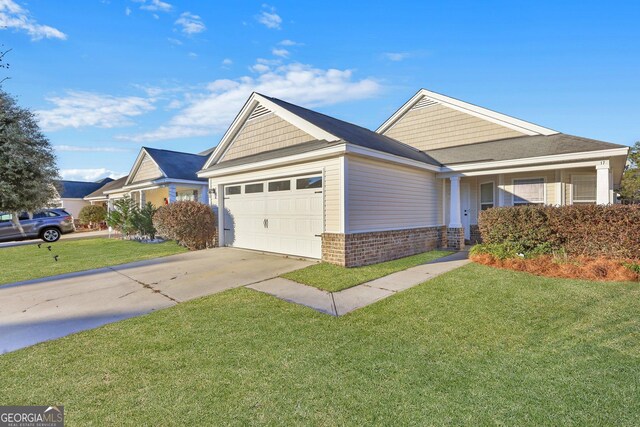 17 Sandy Point Way, Port Wentworth, GA 31407 - view of front of house featuring a garage, brick siding, concrete driveway, and a front lawn