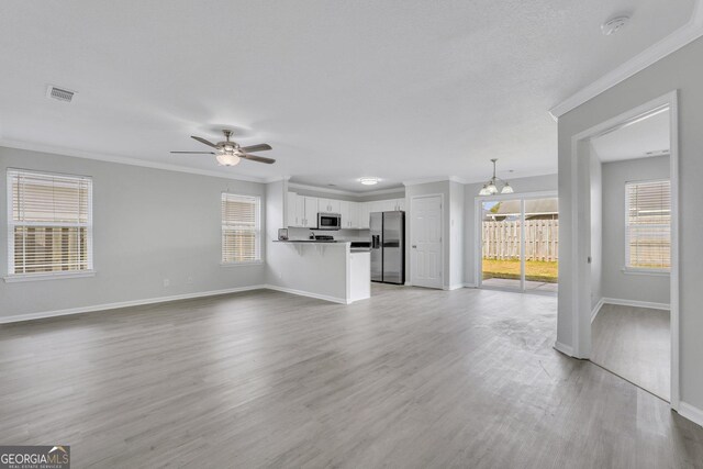 17 Sandy Point Way, Port Wentworth, GA 31407 - unfurnished living room with crown molding, baseboards, healthy amount of natural light, light wood-style floors, and a ceiling fan