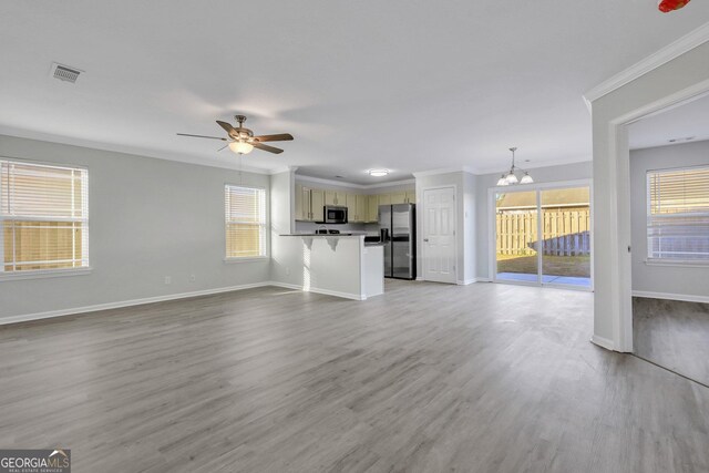 17 Sandy Point Way, Port Wentworth, GA 31407 - unfurnished living room with crown molding, a chandelier, baseboards, ceiling fan, and light wood-type flooring