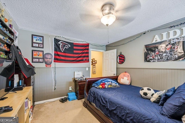 153 Spruce Ln, Gray, GA 31032 - bedroom featuring wainscoting, a textured ceiling, carpet, baseboards, and a ceiling fan