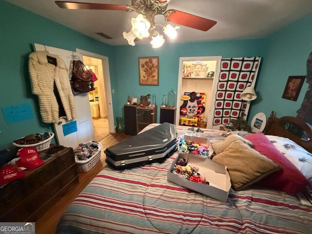 1268 Woodland Rd NE, Conyers, GA 30012 - bedroom with wood finished floors and ceiling fan