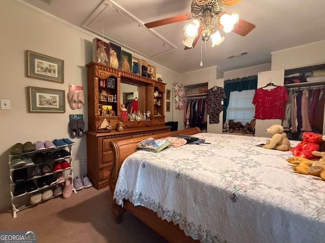 1268 Woodland Rd NE, Conyers, GA 30012 - bedroom with attic access, carpet flooring, two closets, and a ceiling fan