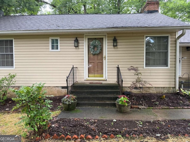 1268 Woodland Rd NE, Conyers, GA 30012 - doorway to property featuring a chimney and a shingled roof