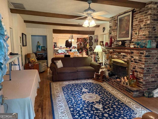 1268 Woodland Rd NE, Conyers, GA 30012 - living room featuring wood finished floors, beamed ceiling, ceiling fan, a fireplace, and wood walls