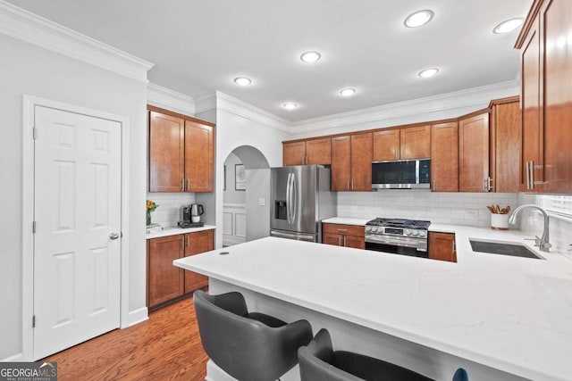 3690 Lambert Ln NE, Atlanta, GA 30319 - kitchen with appliances with stainless steel finishes, crown molding, a peninsula, a sink, and tasteful backsplash