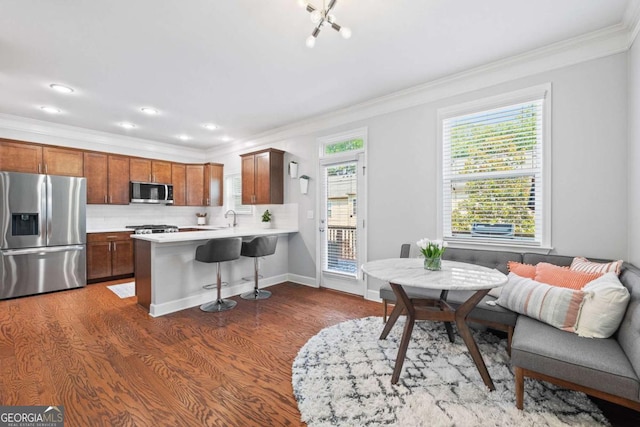 3690 Lambert Ln NE, Atlanta, GA 30319 - kitchen with appliances with stainless steel finishes, ornamental molding, a sink, dark wood finished floors, and light countertops