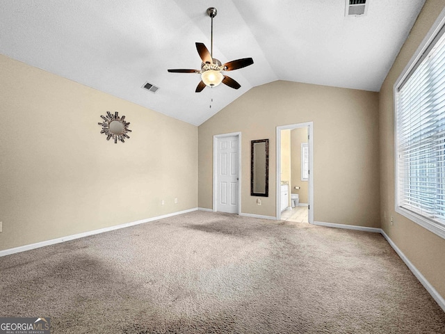118 Hunterian Pl, Newnan, GA 30265 - unfurnished bedroom with light carpet, vaulted ceiling, multiple windows, baseboards, and ensuite bathroom