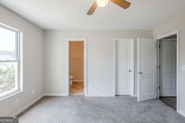 2255 Bigwood Trl, Atlanta, GA 30349 - unfurnished bedroom featuring carpet floors, baseboards, ensuite bath, a textured ceiling, and ceiling fan
