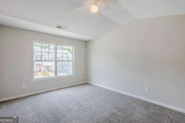 2255 Bigwood Trl, Atlanta, GA 30349 - empty room featuring carpet floors, ceiling fan, baseboards, vaulted ceiling, and a textured ceiling