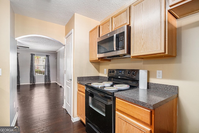 3262 Cascade Parc Blvd SW, Atlanta, GA 30311 - kitchen with black electric range oven, stainless steel microwave, arched walkways, a textured ceiling, and dark countertops