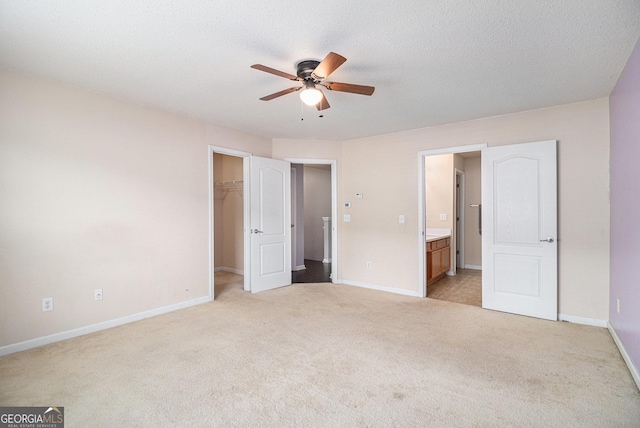 3262 Cascade Parc Blvd SW, Atlanta, GA 30311 - unfurnished bedroom with light colored carpet, a walk in closet, connected bathroom, a closet, and a ceiling fan