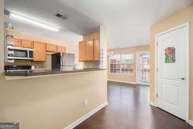 3262 Cascade Parc Blvd SW, Atlanta, GA 30311 - kitchen featuring stainless steel microwave, freestanding refrigerator, stove, dark wood finished floors, and a peninsula