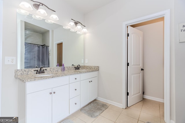 1243 Glenville Ct, Hoschton, GA 30548 - full bathroom featuring double vanity, tile patterned flooring, and baseboards