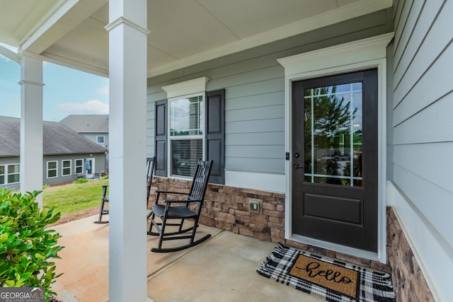 1243 Glenville Ct, Hoschton, GA 30548 - entrance to property featuring covered porch and stone siding