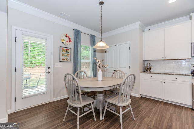 1243 Glenville Ct, Hoschton, GA 30548 - dining area with dark wood finished floors, baseboards, and crown molding