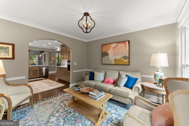 1540 Kinglet Ln, Marietta, GA 30062 - living area featuring arched walkways, dark wood-type flooring, a chandelier, ornamental molding, and baseboards