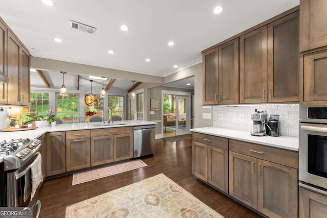 1540 Kinglet Ln, Marietta, GA 30062 - kitchen featuring appliances with stainless steel finishes, a peninsula, backsplash, ornamental molding, and light countertops
