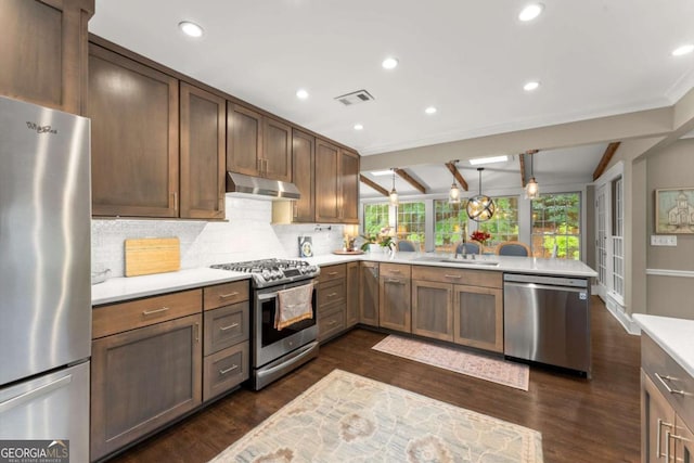 1540 Kinglet Ln, Marietta, GA 30062 - kitchen with appliances with stainless steel finishes, under cabinet range hood, a peninsula, light countertops, and a sink