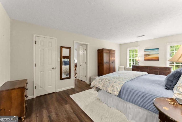 1540 Kinglet Ln, Marietta, GA 30062 - bedroom featuring wood finished floors, baseboards, and a textured ceiling