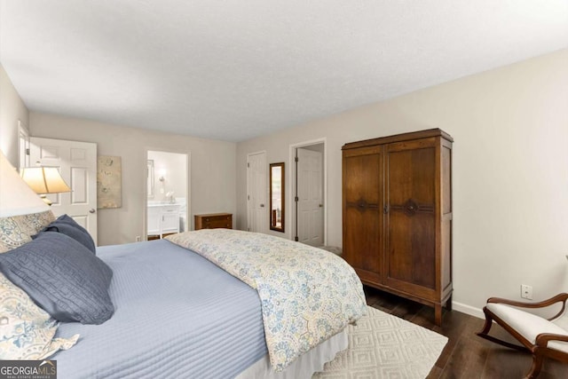 1540 Kinglet Ln, Marietta, GA 30062 - bedroom with baseboards, dark wood-style floors, and ensuite bath