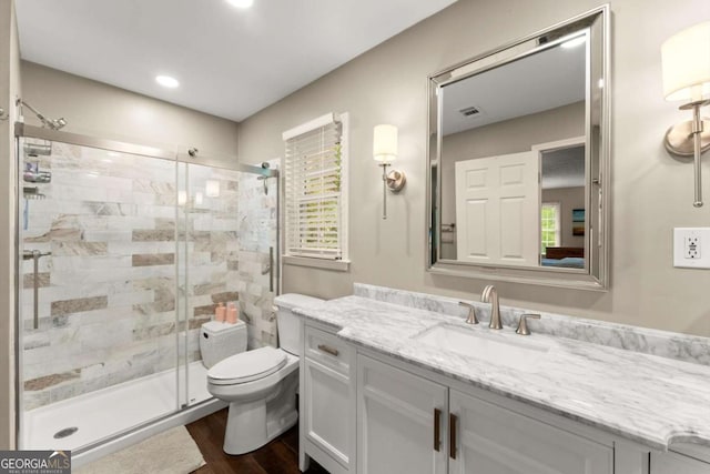 1540 Kinglet Ln, Marietta, GA 30062 - bathroom with vanity, a shower stall, toilet, wood finished floors, and recessed lighting