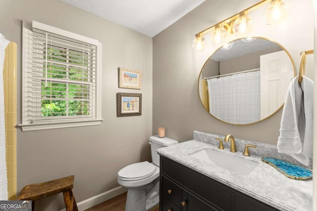 1540 Kinglet Ln, Marietta, GA 30062 - full bath featuring vanity, toilet, wood finished floors, and baseboards