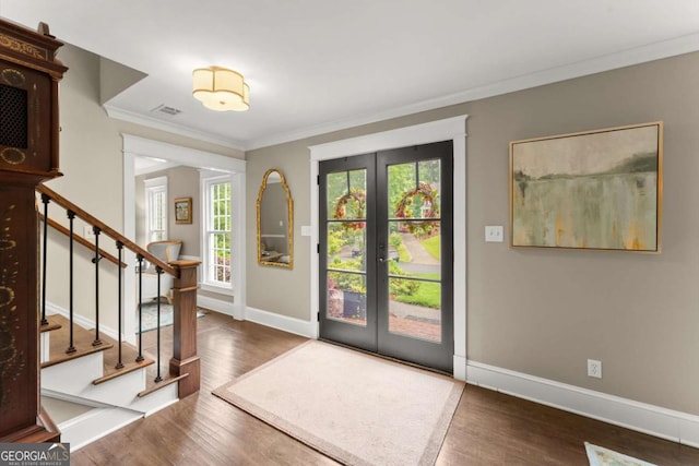 1540 Kinglet Ln, Marietta, GA 30062 - foyer entrance with french doors, wood finished floors, stairs, and crown molding