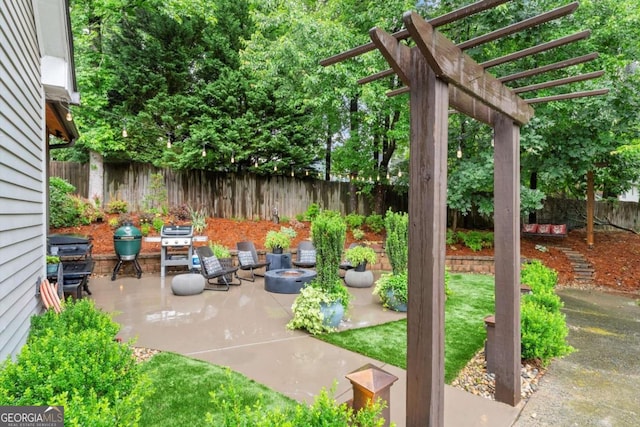 1540 Kinglet Ln, Marietta, GA 30062 - fenced backyard with a patio area, an outdoor fire pit, and a pergola