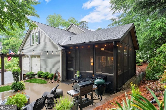 1540 Kinglet Ln, Marietta, GA 30062 - rear view of property with a sunroom, a shingled roof, and a garage