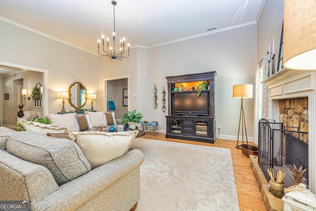 172 Walden Pond Trl, Senoia, GA 30276 - living room featuring baseboards, a chandelier, crown molding, and light wood-style floors