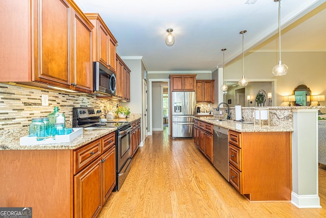 172 Walden Pond Trl, Senoia, GA 30276 - kitchen with stainless steel appliances, a sink, light wood finished floors, tasteful backsplash, and brown cabinetry