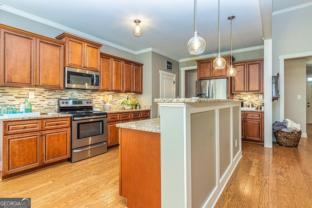 172 Walden Pond Trl, Senoia, GA 30276 - kitchen featuring appliances with stainless steel finishes, light wood-style flooring, decorative backsplash, brown cabinetry, and ornamental molding
