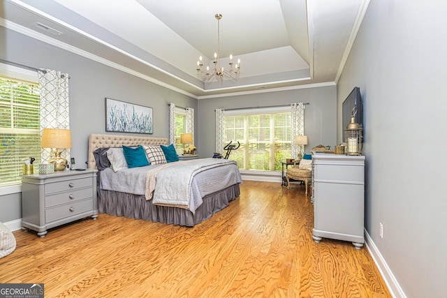 172 Walden Pond Trl, Senoia, GA 30276 - bedroom with a chandelier, light wood-type flooring, crown molding, multiple windows, and a raised ceiling