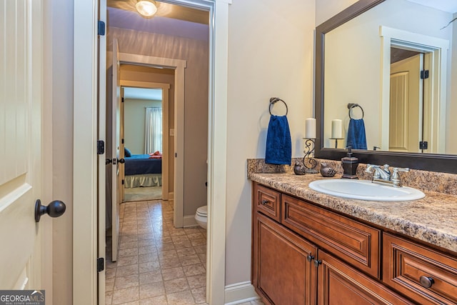 172 Walden Pond Trl, Senoia, GA 30276 - bathroom with toilet, vanity, baseboards, and ensuite bathroom