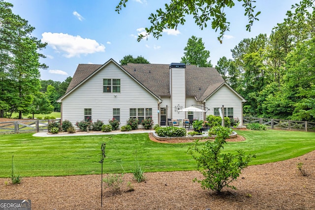 172 Walden Pond Trl, Senoia, GA 30276 - back of house with a patio, roof with shingles, and a chimney