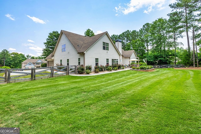 172 Walden Pond Trl, Senoia, GA 30276 - view of side of home with a chimney, a garage, driveway, and a gate