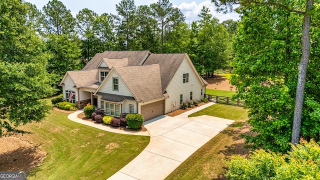 172 Walden Pond Trl, Senoia, GA 30276 - view of front facade with roof with shingles, a garage, driveway, and view of wooded area