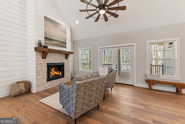 219 Fairview Dr, Morganton, GA 30560 - living area featuring a ceiling fan, hardwood / wood-style flooring, a stone fireplace, french doors, and high vaulted ceiling