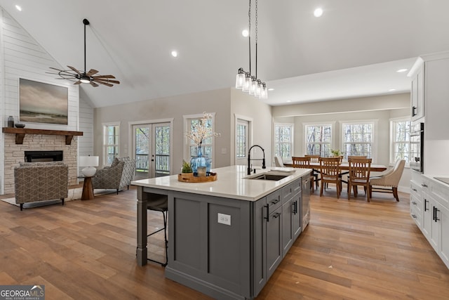 219 Fairview Dr, Morganton, GA 30560 - kitchen with gray cabinetry, high vaulted ceiling, light wood-type flooring, light countertops, and a ceiling fan