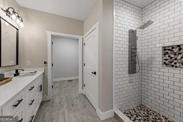 219 Fairview Dr, Morganton, GA 30560 - bathroom with vanity, tiled shower, and wood finished floors