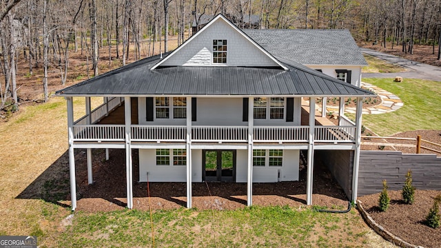 219 Fairview Dr, Morganton, GA 30560 - back of house with a metal roof, a yard, a view of trees, and roof with shingles