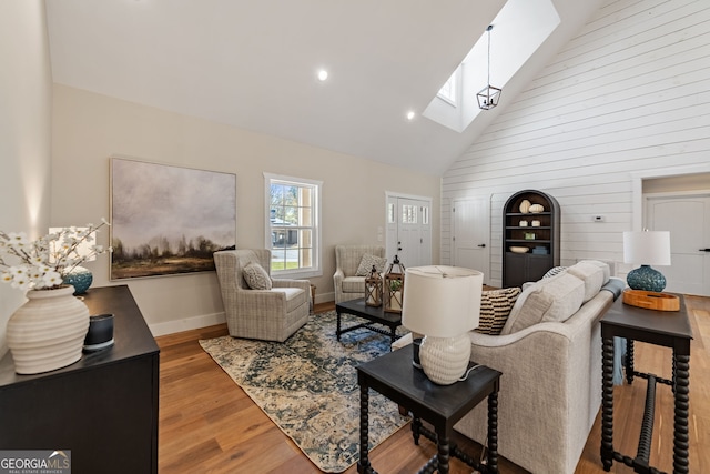 219 Fairview Dr, Morganton, GA 30560 - living area featuring a skylight, high vaulted ceiling, wood finished floors, wood walls, and recessed lighting
