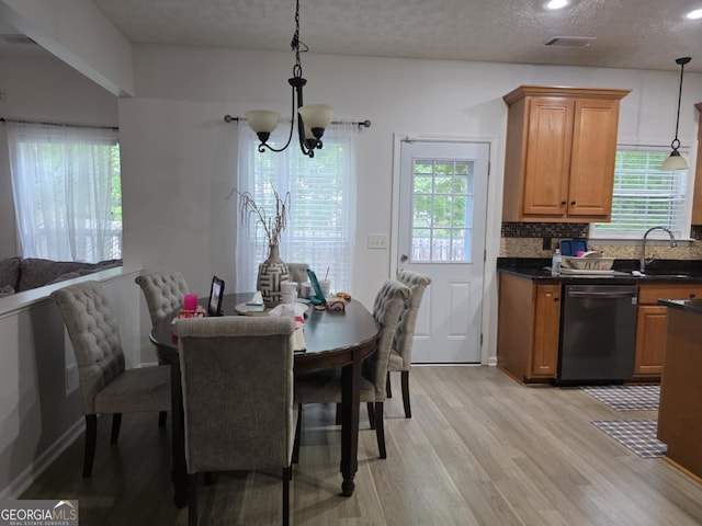10315 Whisper Glen Dr, Midland, GA 31820 - dining area featuring light wood-type flooring, a chandelier, recessed lighting, and a textured ceiling